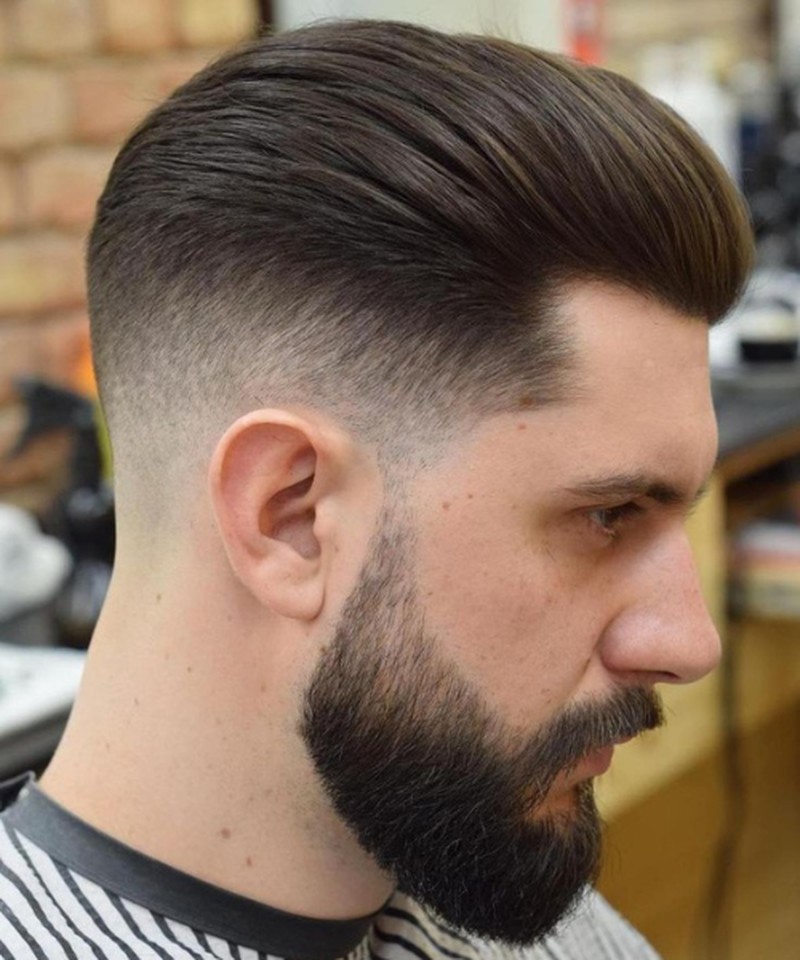 A low fade haircut with a smooth, textured top and a clean, gradual taper down the sides.
