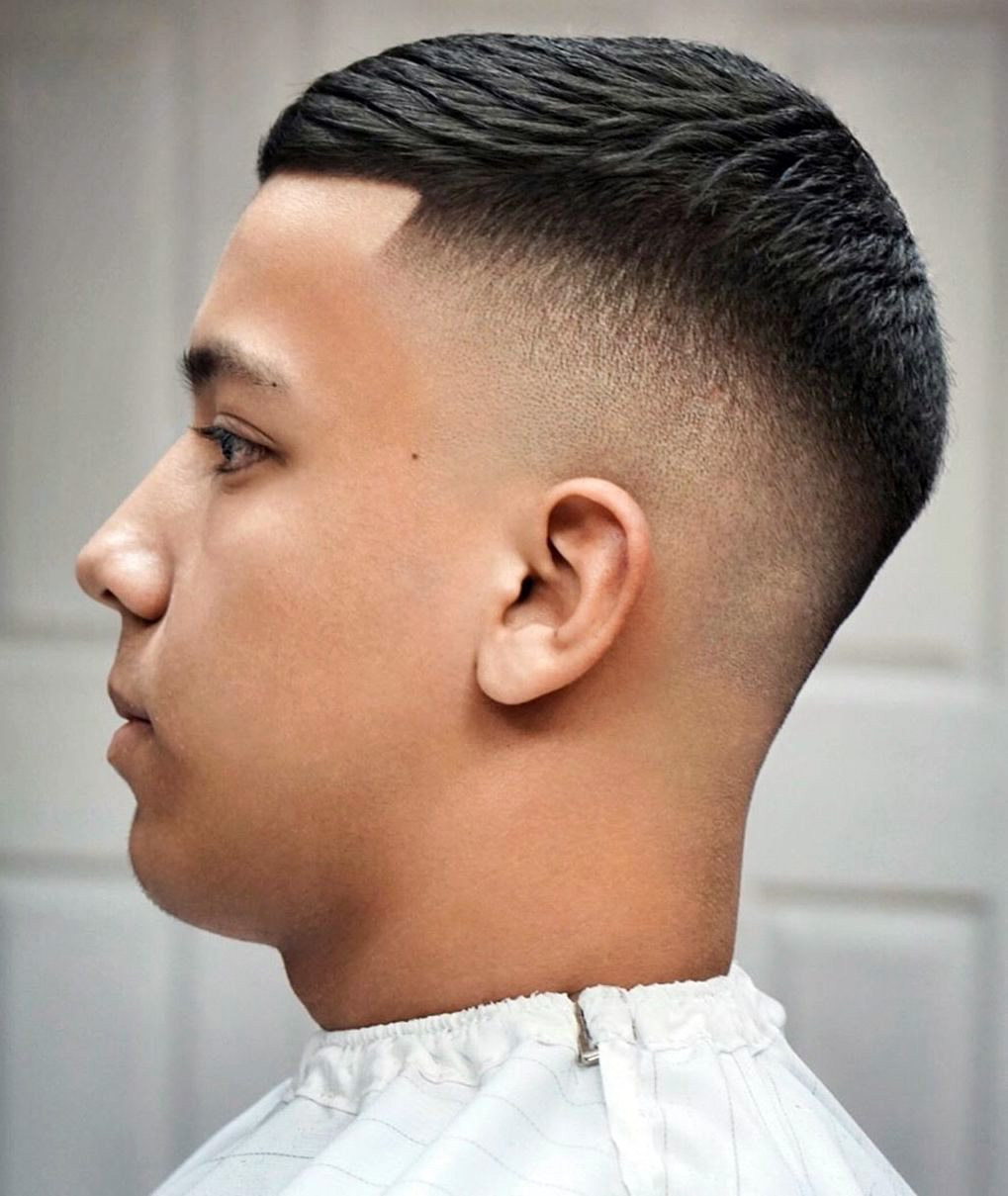 Burst Fade Drop Hybrid: Textured top, sharp burst fade, clean drop line, modern men’s haircut.