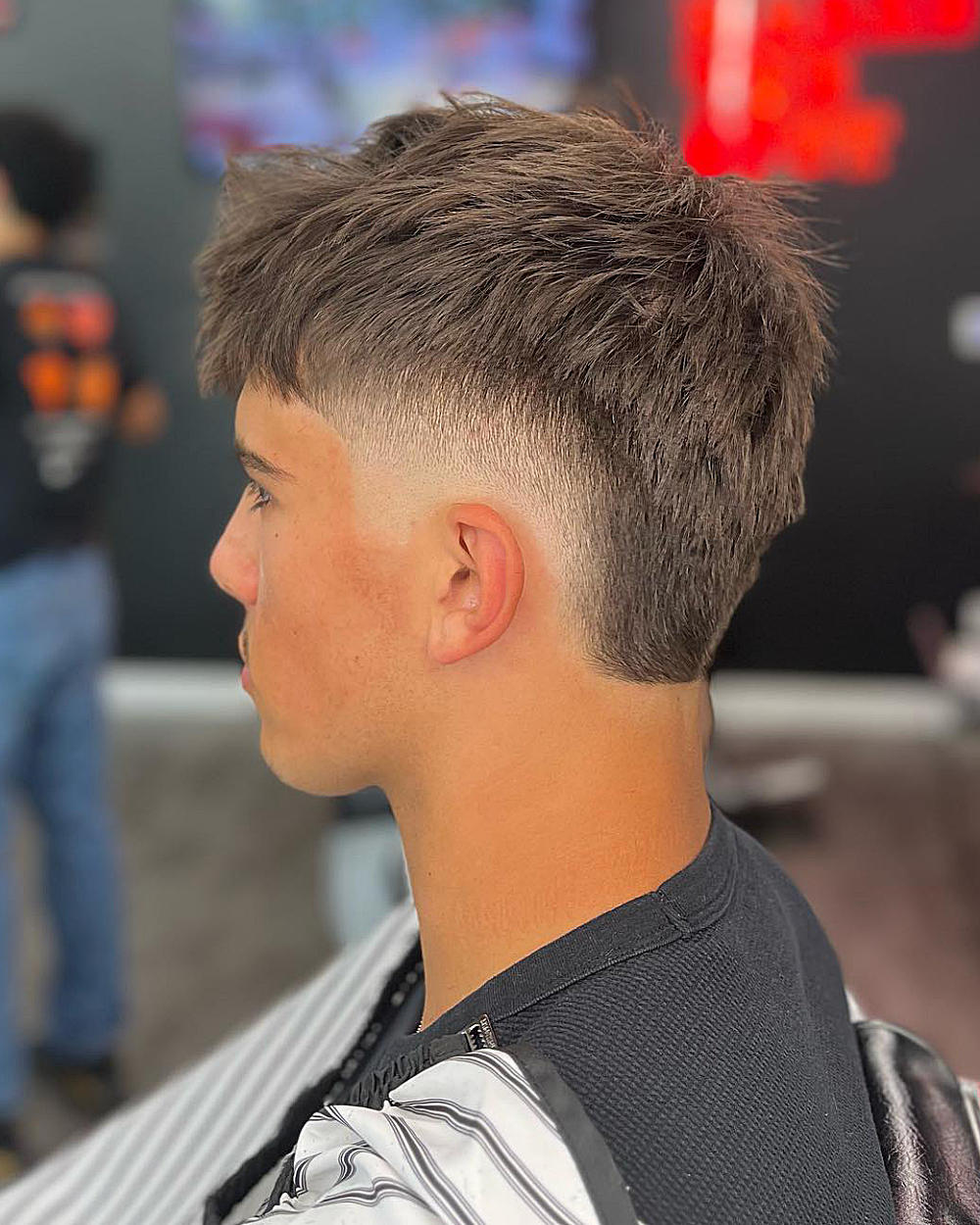Drop fade mullet: textured, voluminous top; sharp drop fade from mid-lengths to skin; clean, modern mullet silhouette.