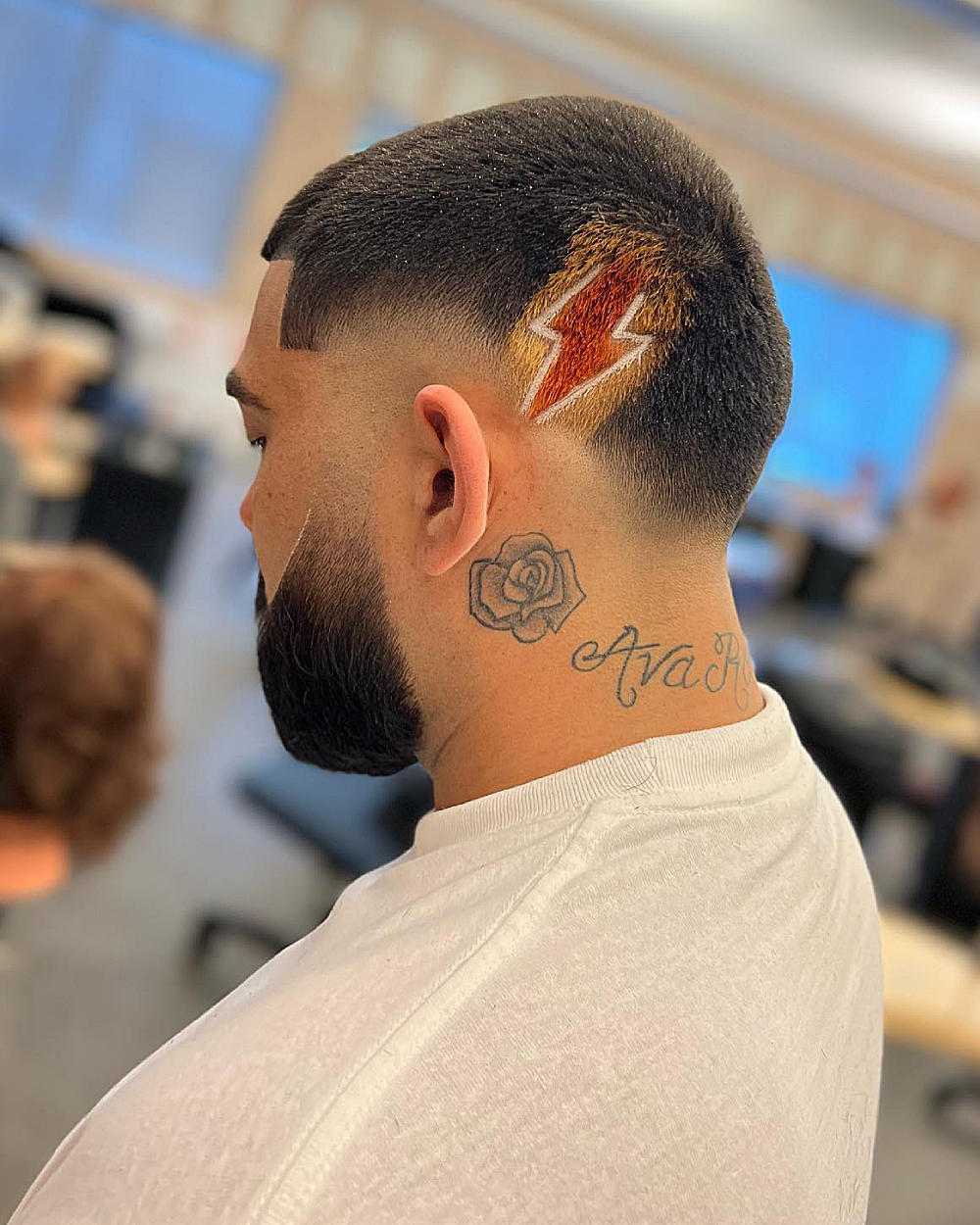 High drop fade with a sharp lightning bolt design, textured top, clean fade to skin.
