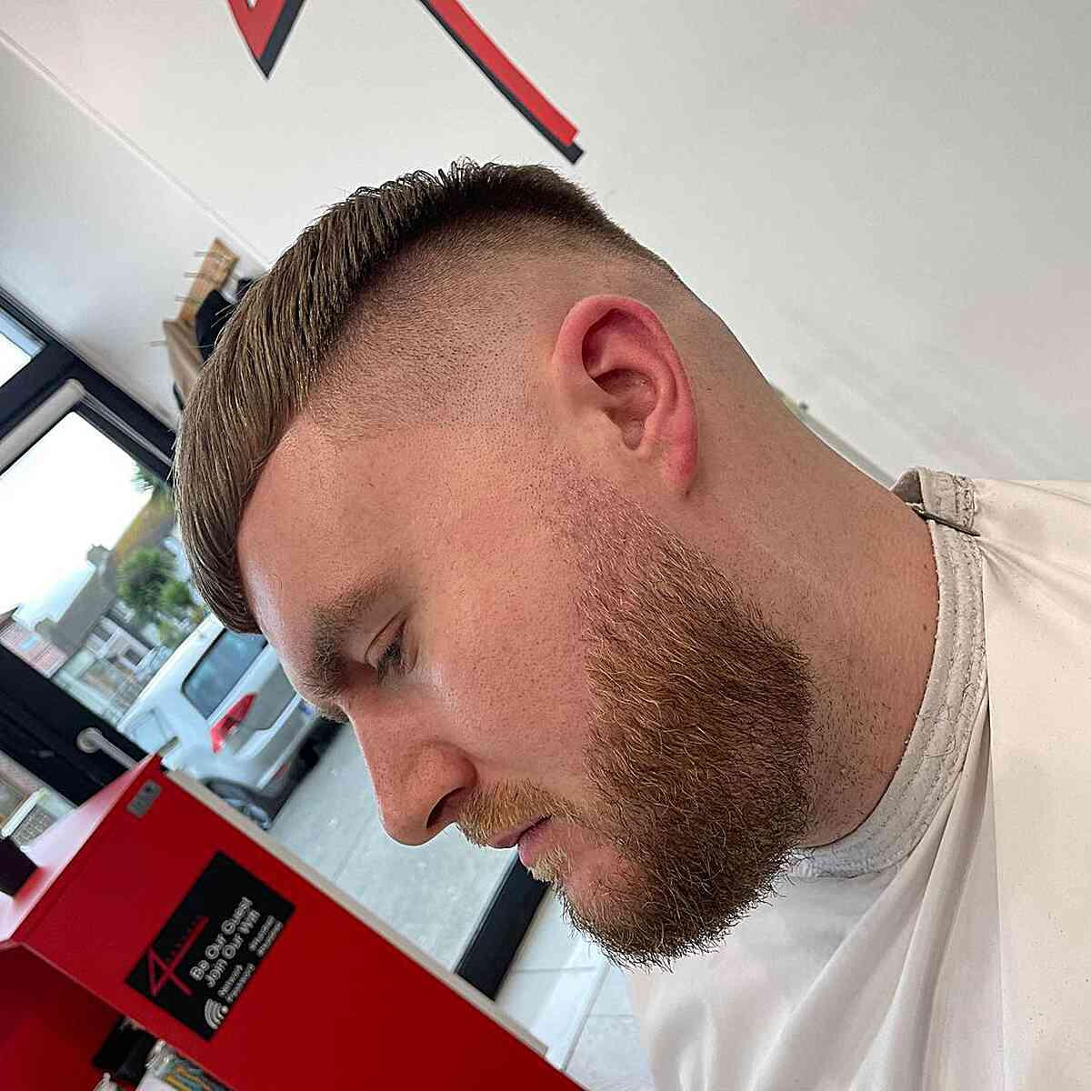 High drop fade with disconnected top: sharp disconnect line, textured top, clean fade from mid-lengths to skin.
