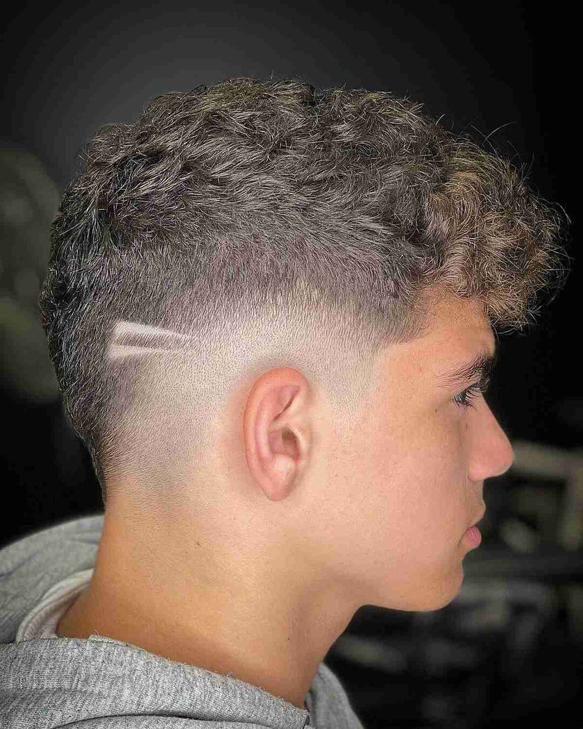 Mixed Texture Drop Fade: Curly/wavy top with inconsistent texture, sharp drop fade, clean hard part, textured volume.