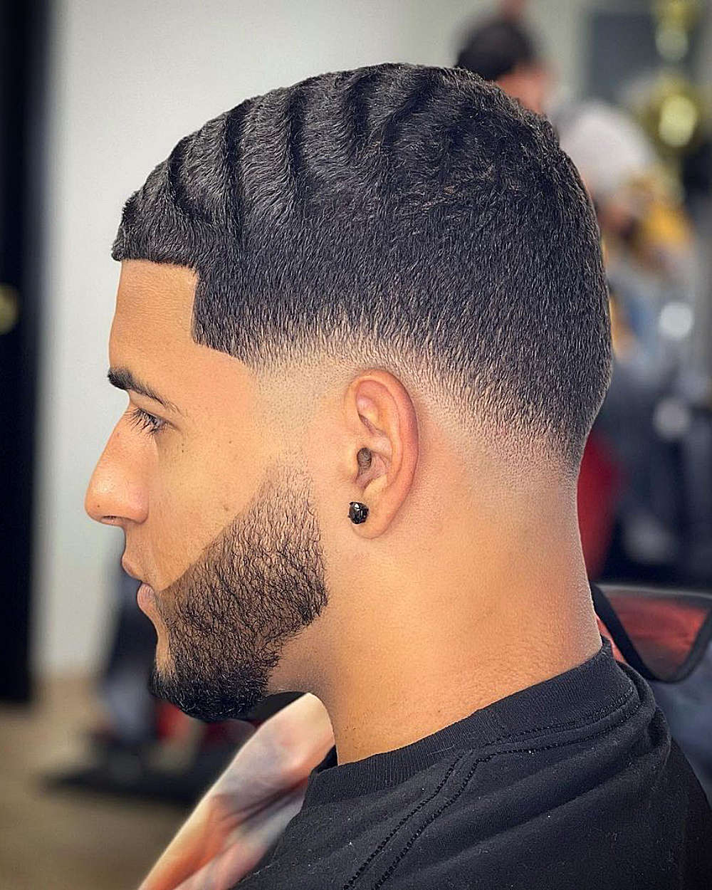 Short textured top with hard part, mid fade, and clean lines.