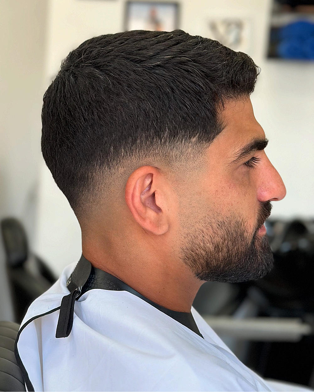 Slick back drop fade: textured, combed-back top with a sharp, gradual fade from mid-lengths to skin, clean and polished.