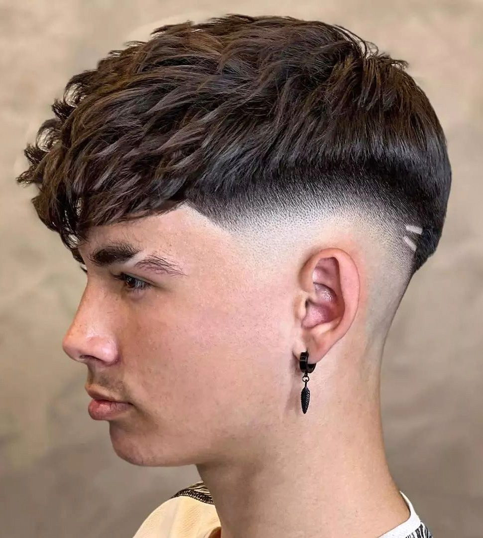 Straight, textured crop with volume on top, sharp drop fade blending to skin, clean lines and subtle design.