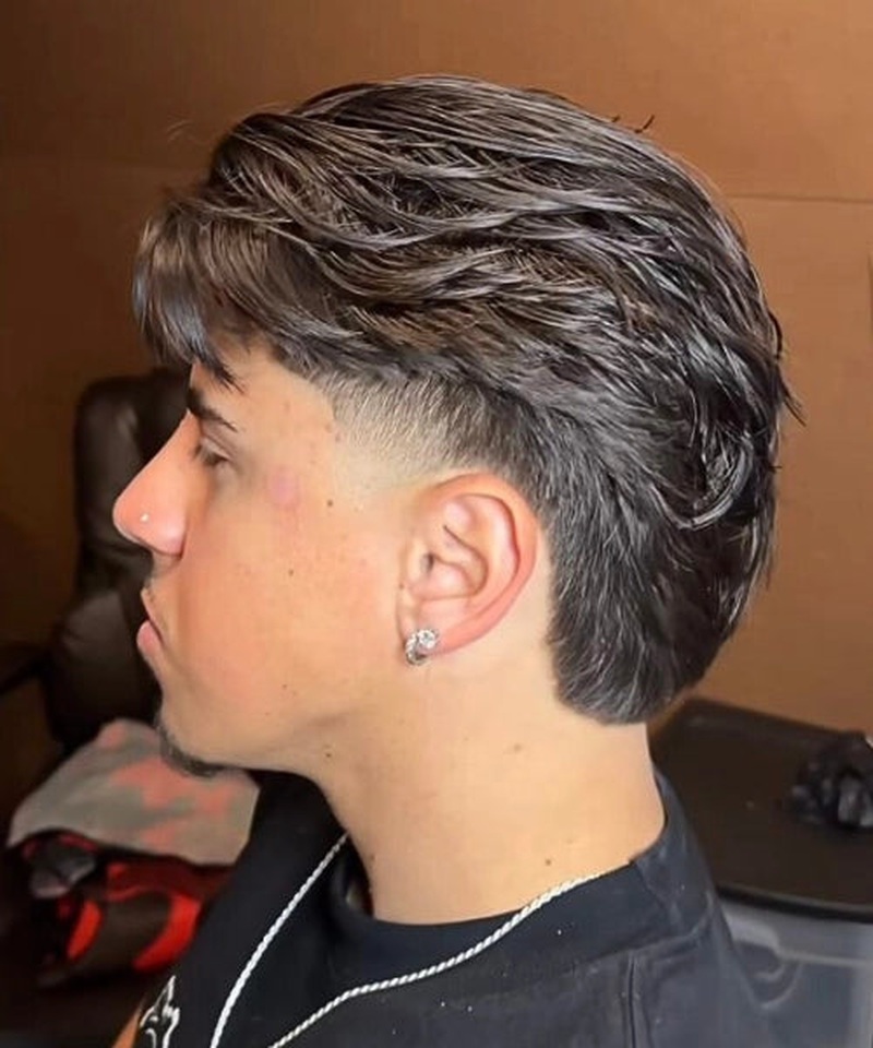 Subtle taper mullet haircut with short sides, longer back, and business-in-front party-in-back style.