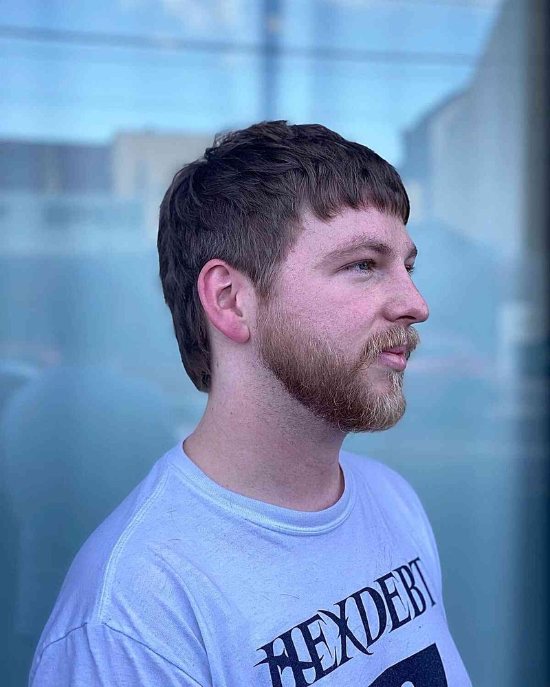 Man with a Ivy League mullet haircut showing short textured crop, low fade, and tapered sides.