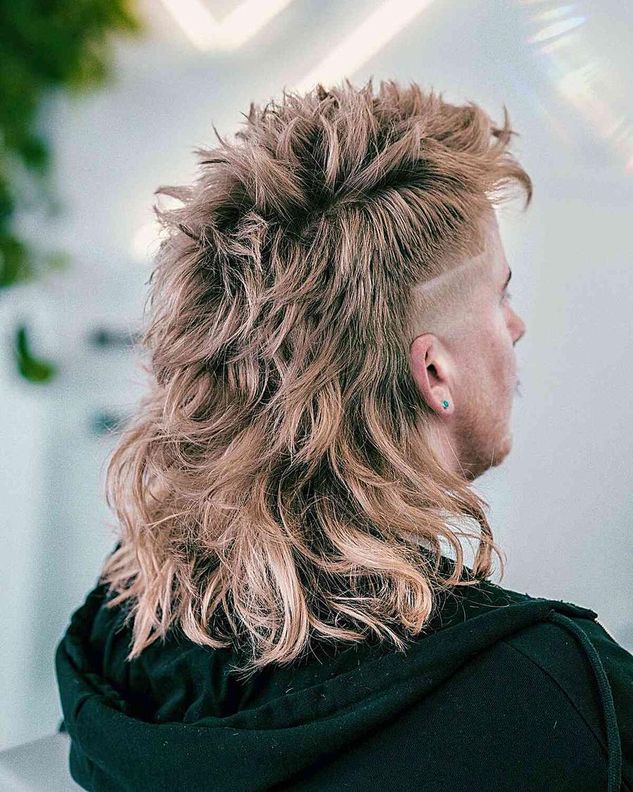 A person with a textured, layered blonde hairstyle featuring a shaved side and a small turquoise earring, viewed from behind.