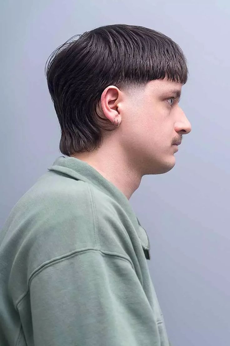 Short, textured top with medium volume; clean low fade on sides.