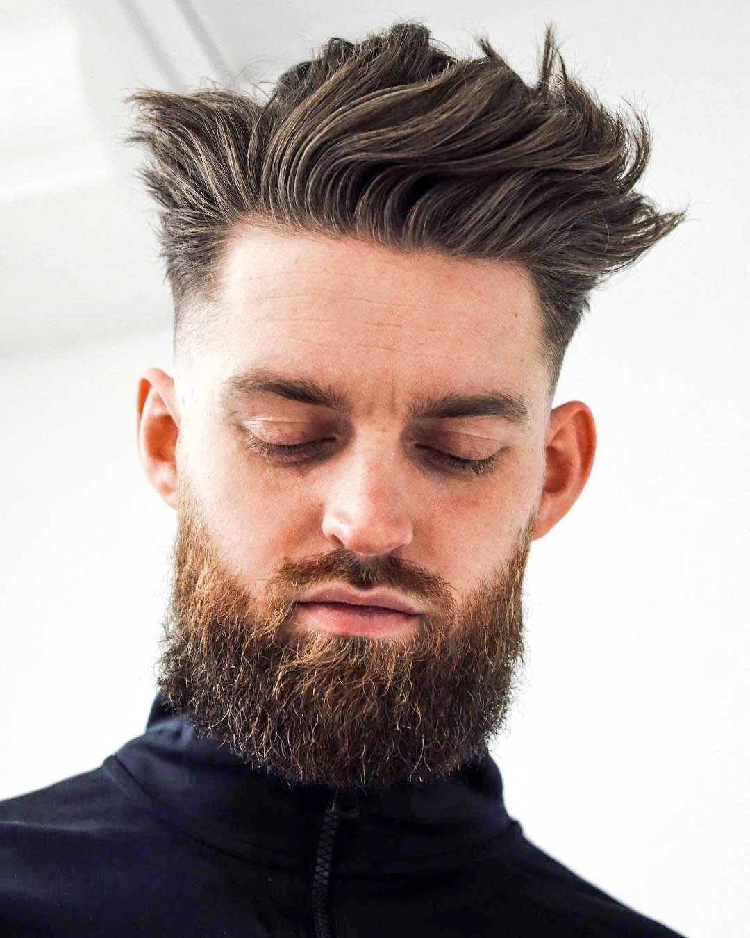 Short, textured top with swept-back volume; sharp fade on sides.